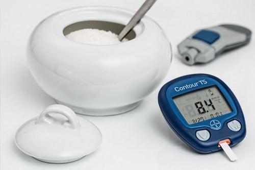 Contour brand diabetes insulin meter next to a bowl of sugar