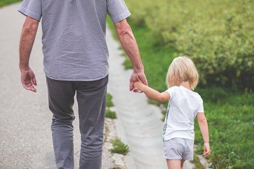 man walking outside with small child