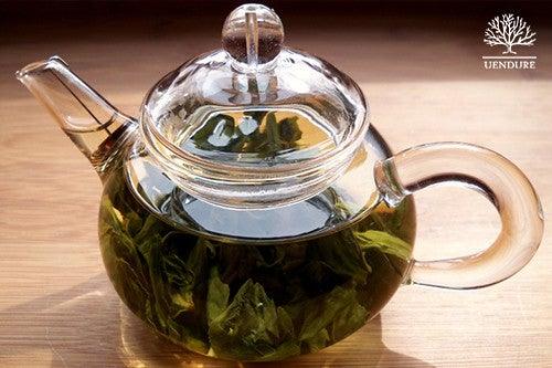 blooming tea flower in clear teapot