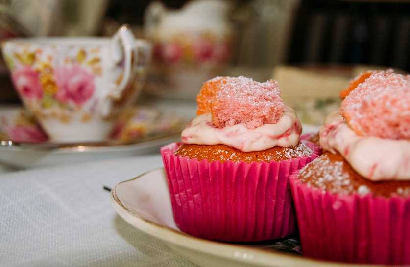 teacup and cupcakes in the forefront