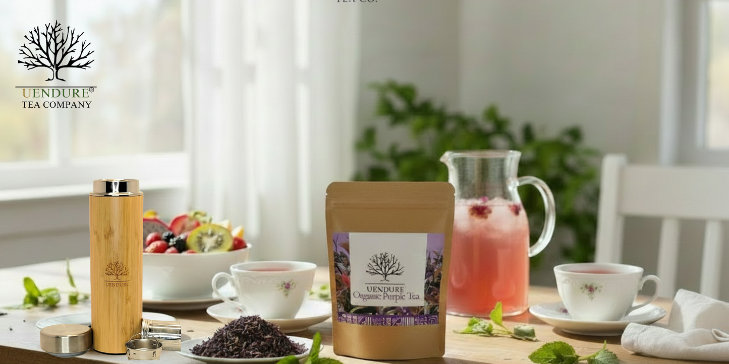 Lendure Tea Company Lavender and Rose Hip tea pouch displayed on a dining table with a bamboo travel mug, teacups, a pitcher of pink tea, and fresh mint leaves in a bright, modern room.