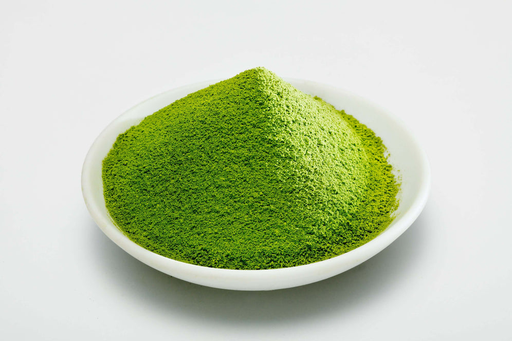 A bowl of finely powdered green matcha representing Blueberry Matcha Organic product.
