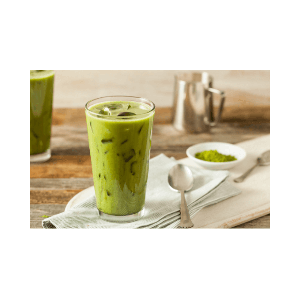 Refreshing iced matcha drink served in a glass on a wooden table with matcha powder and utensils.